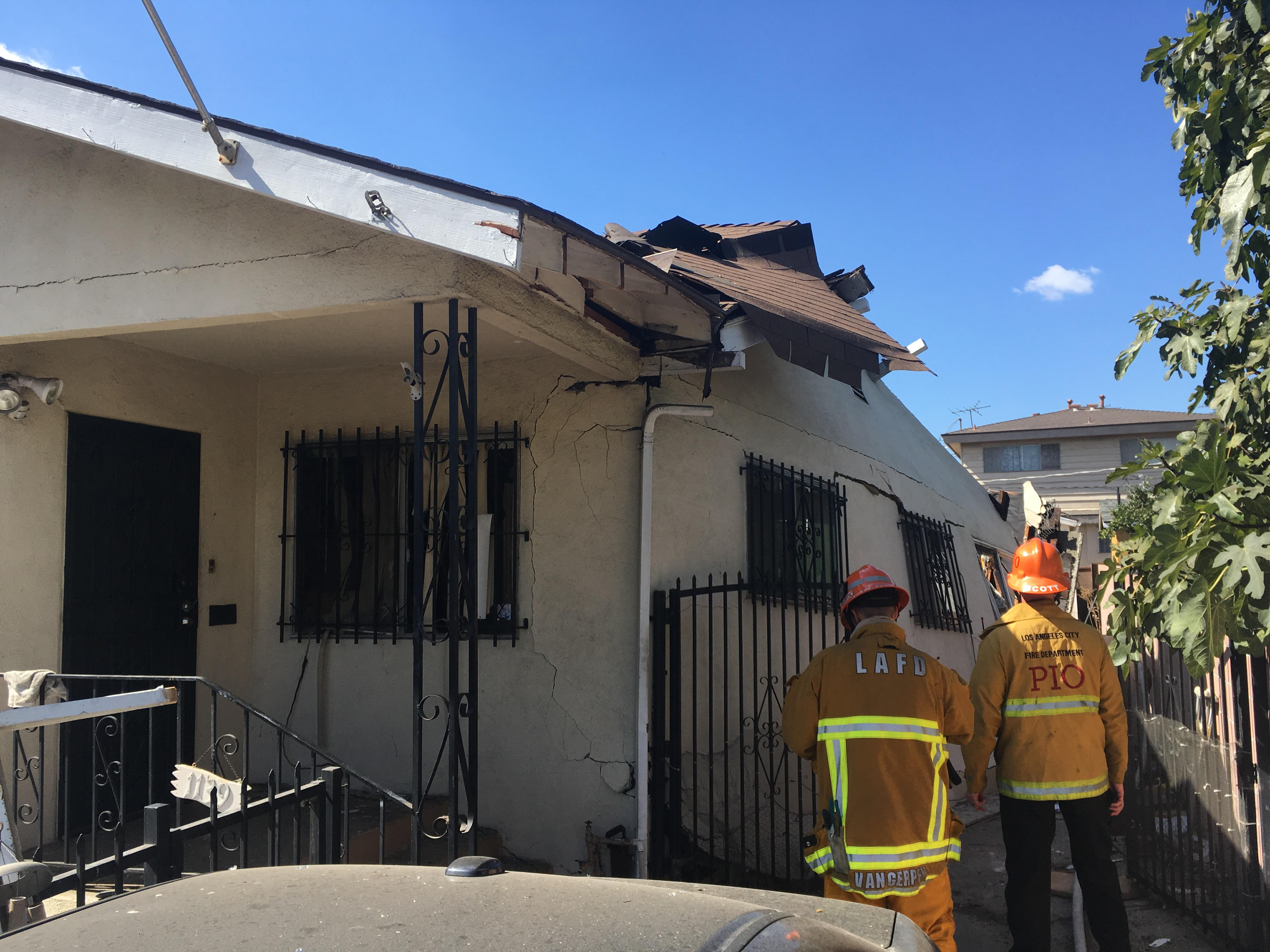 One-story home with significant structural damage from an explosion.