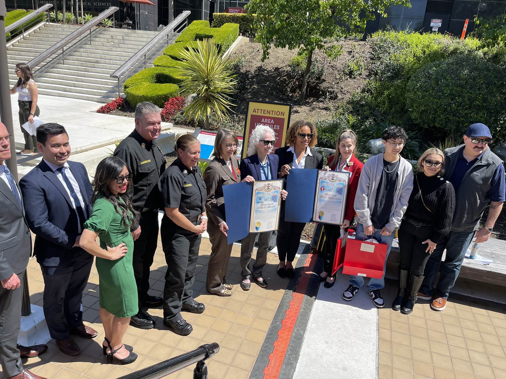 Officials including LAFD Fire Chief Crowley, LACoFD Fire Chief Marrone, LA County Medical Director Barbara Ferrer and others pose for a photo at the event